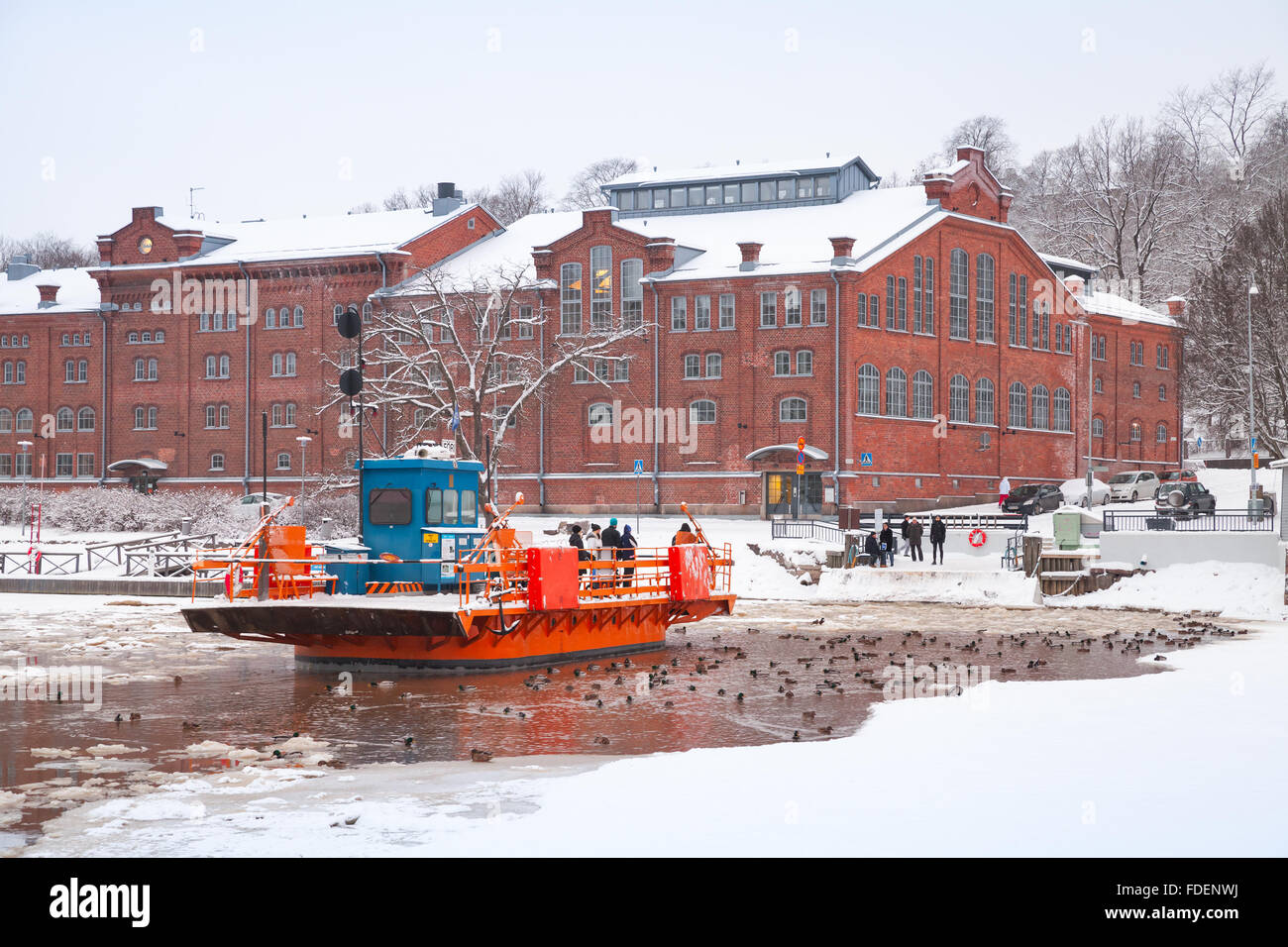 Turku, Finland - January 17, 2016: Ordinary people go on city boat Fori, light traffic ferry that has served the Aura River Stock Photo