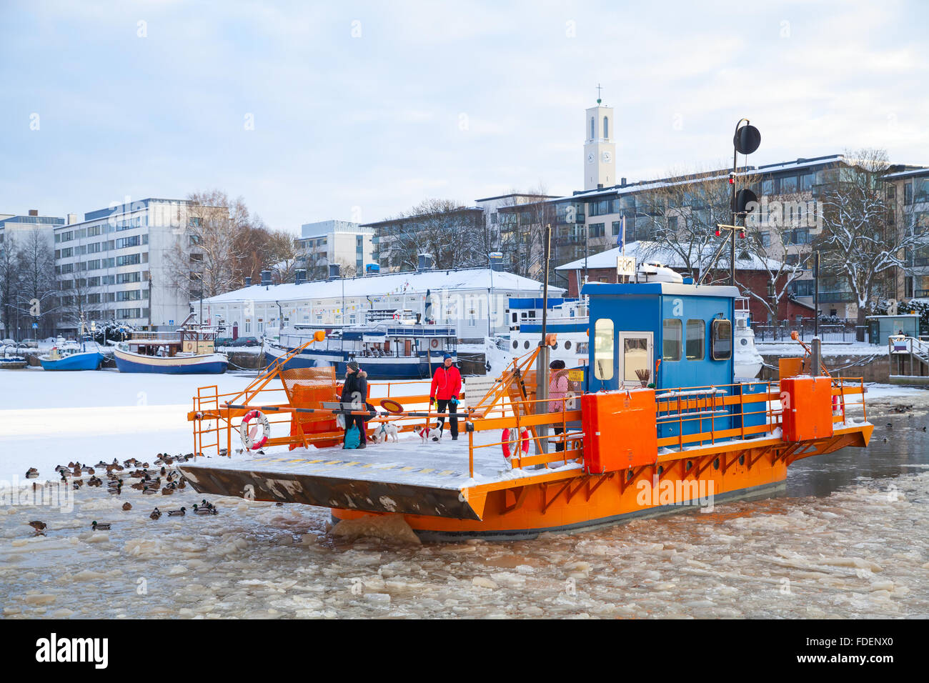 Turku, Finland - January 22, 2016: Ordinary passengers go on city boat Fori, light traffic ferry that has served the Aura River Stock Photo