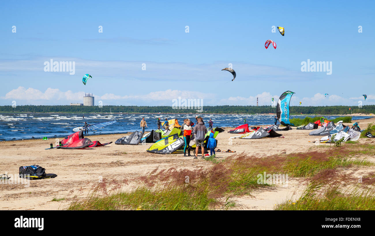 Sosnovy Bor, Russia - July 19, 2015: Kitesurfers on the beach prepare sport equipment for riding. Gulf of Finland, Russia Stock Photo