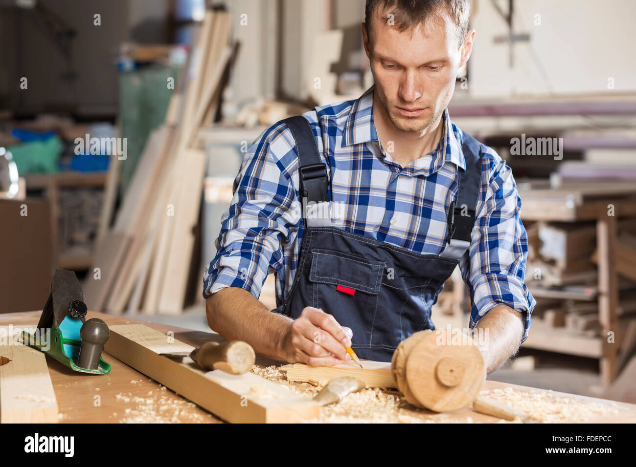 Young carpenter working with cutter in his studio Stock Photo - Alamy