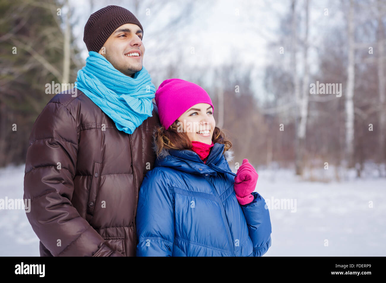 Happy young couple in winter park having fun Stock Photo - Alamy
