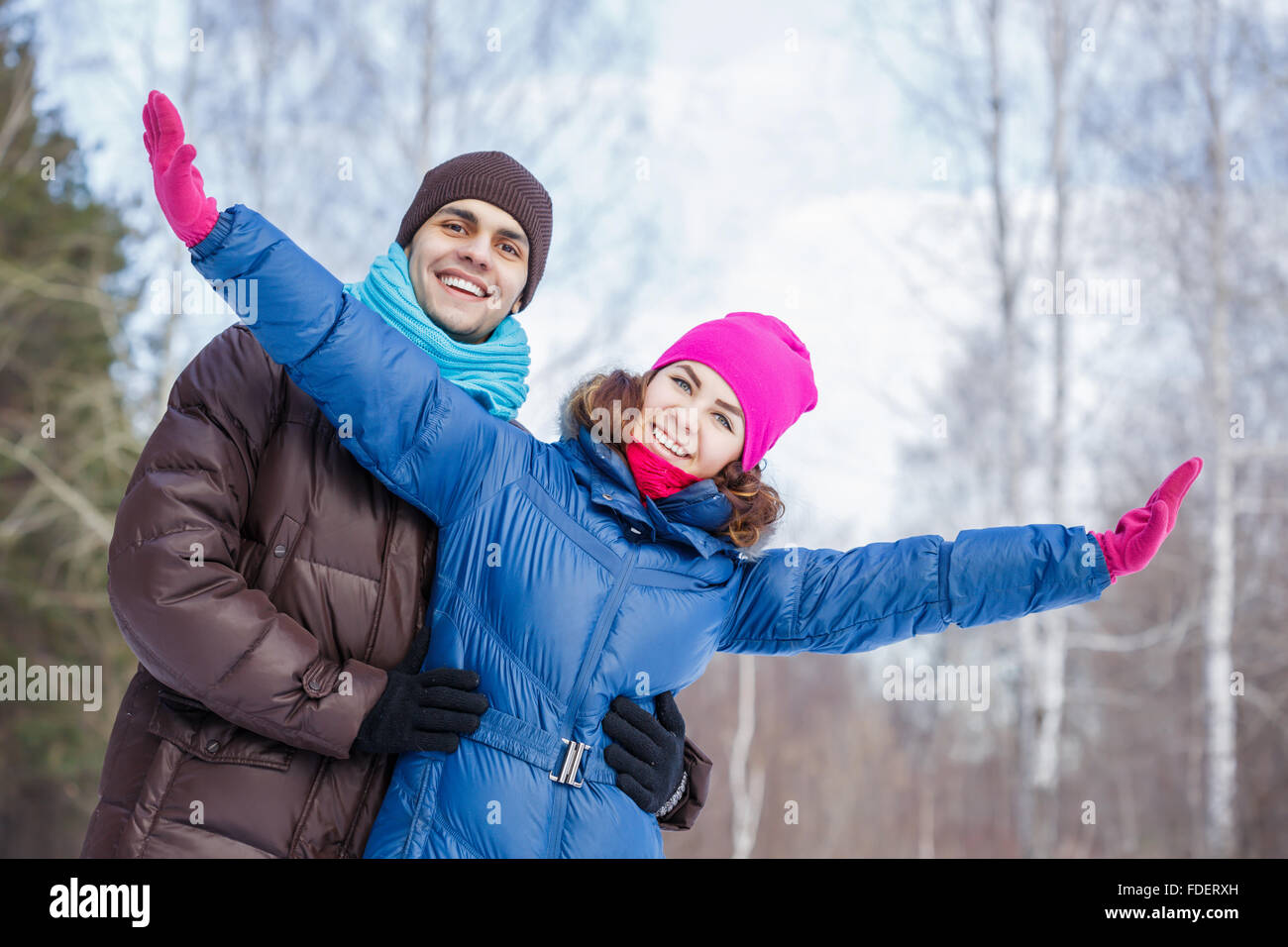 Happy young couple in winter park having fun Stock Photo - Alamy