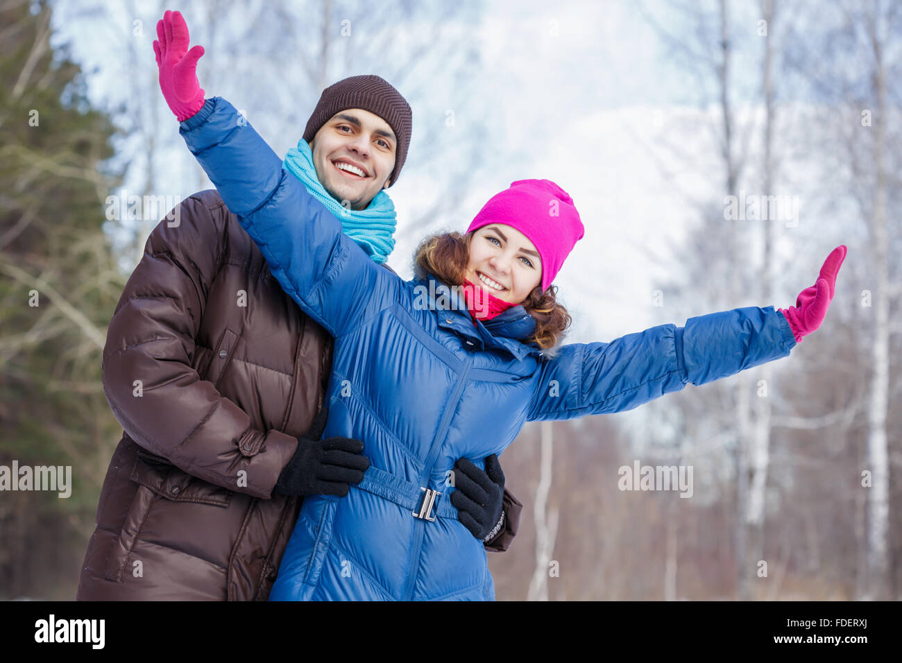 Happy young couple in winter park having fun Stock Photo - Alamy