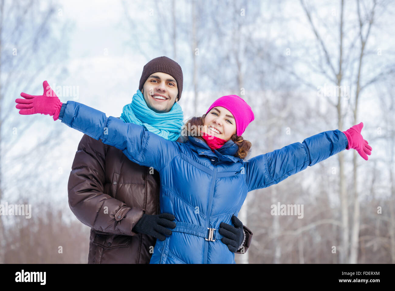 Happy young couple in winter park having fun Stock Photo - Alamy