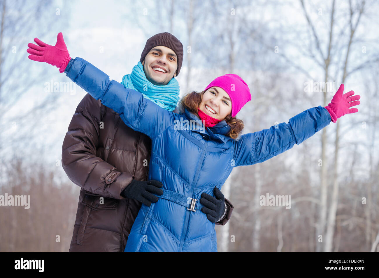 Happy young couple in winter park having fun Stock Photo - Alamy
