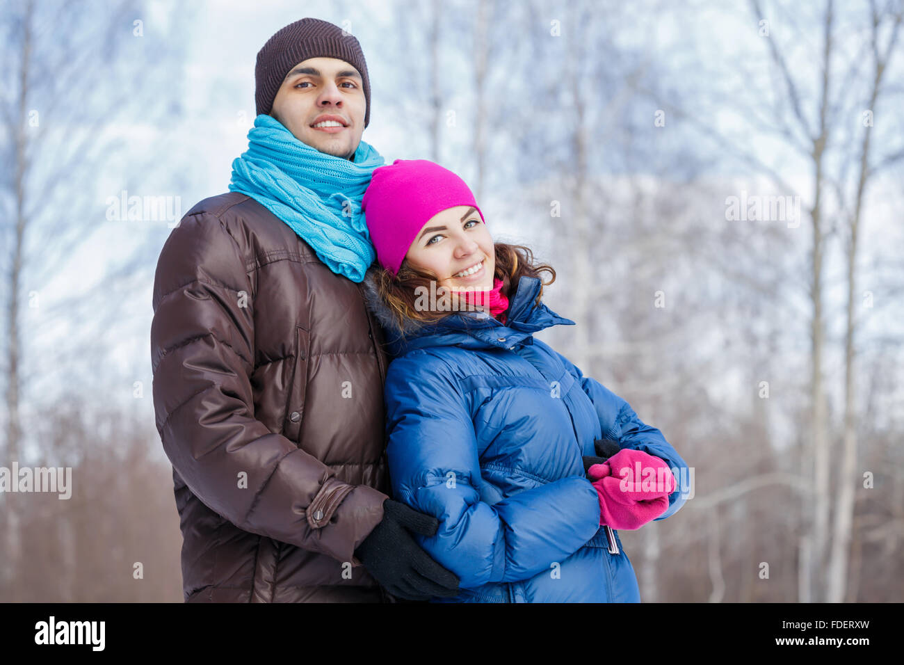 Happy young couple in winter park having fun Stock Photo - Alamy