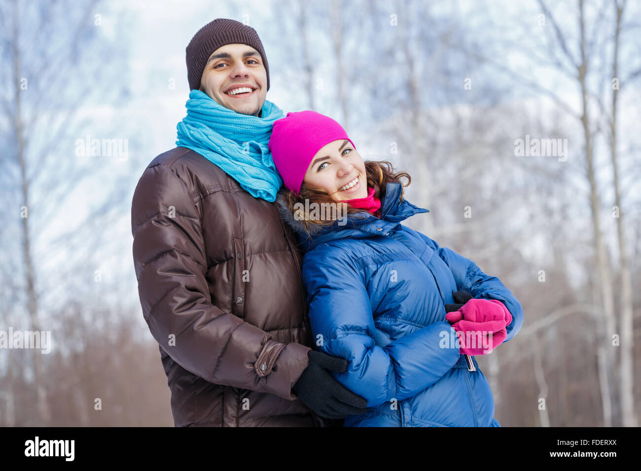 Happy young couple in winter park having fun Stock Photo - Alamy