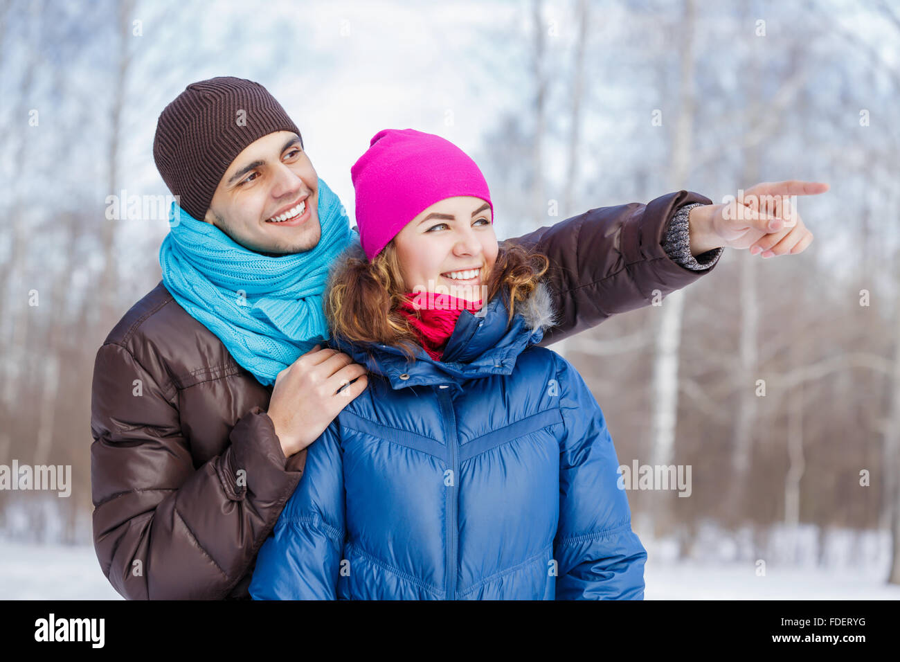Happy young couple in winter park having fun Stock Photo - Alamy