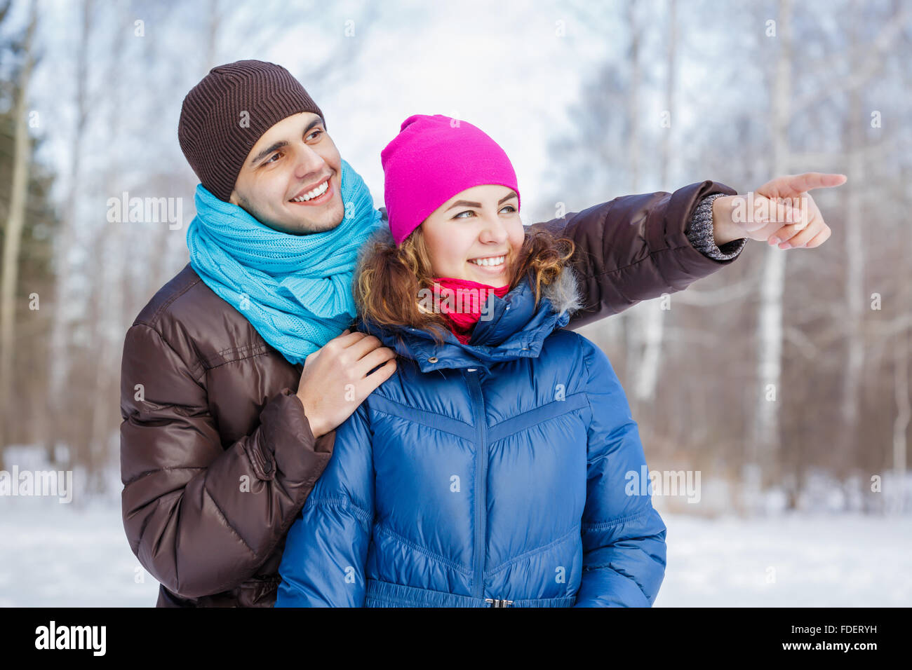 Happy young couple in winter park having fun Stock Photo - Alamy