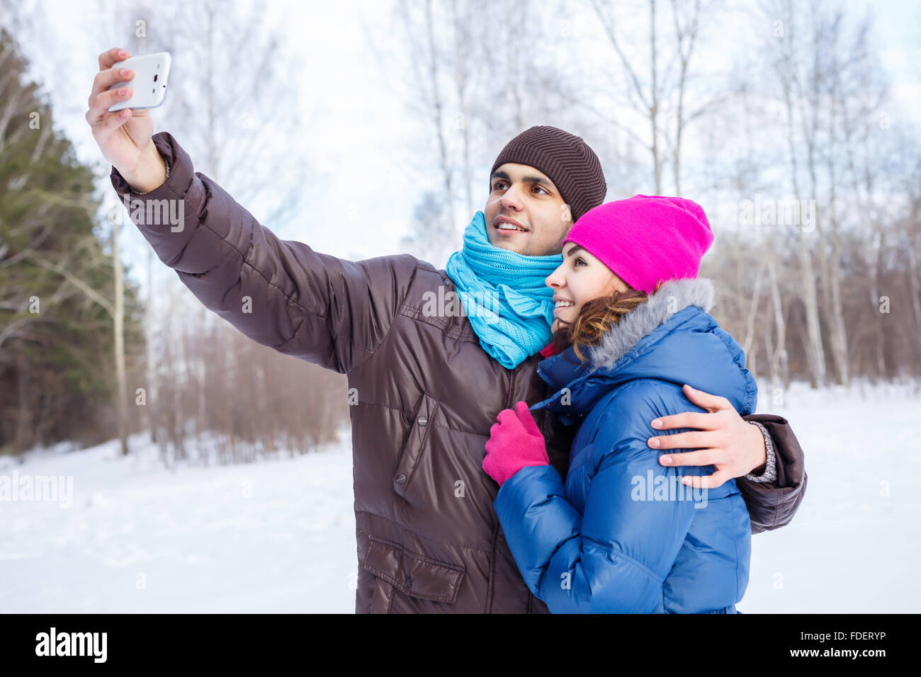 Happy young couple in winter park having fun Stock Photo - Alamy