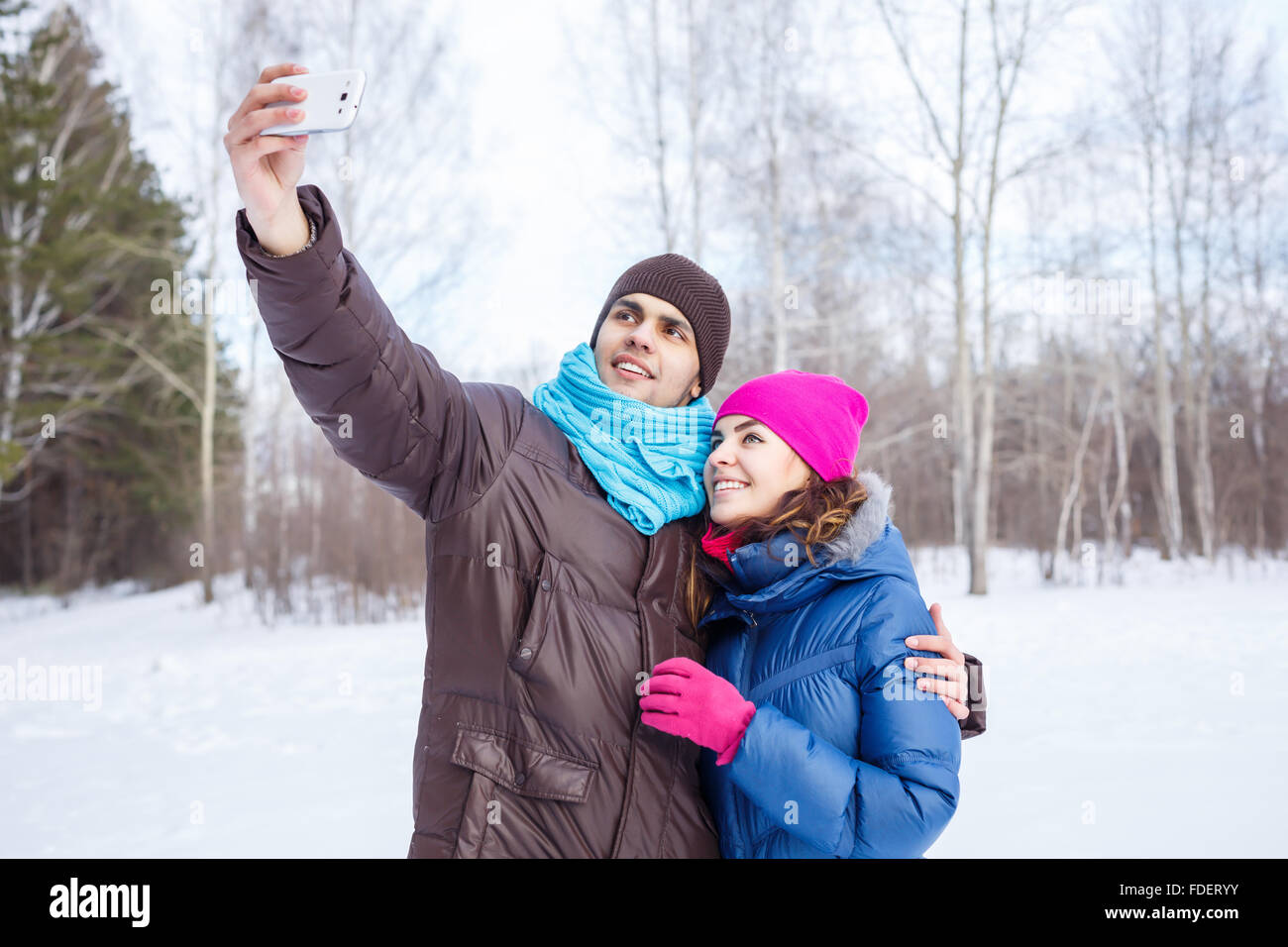 Happy young couple in winter park having fun Stock Photo - Alamy