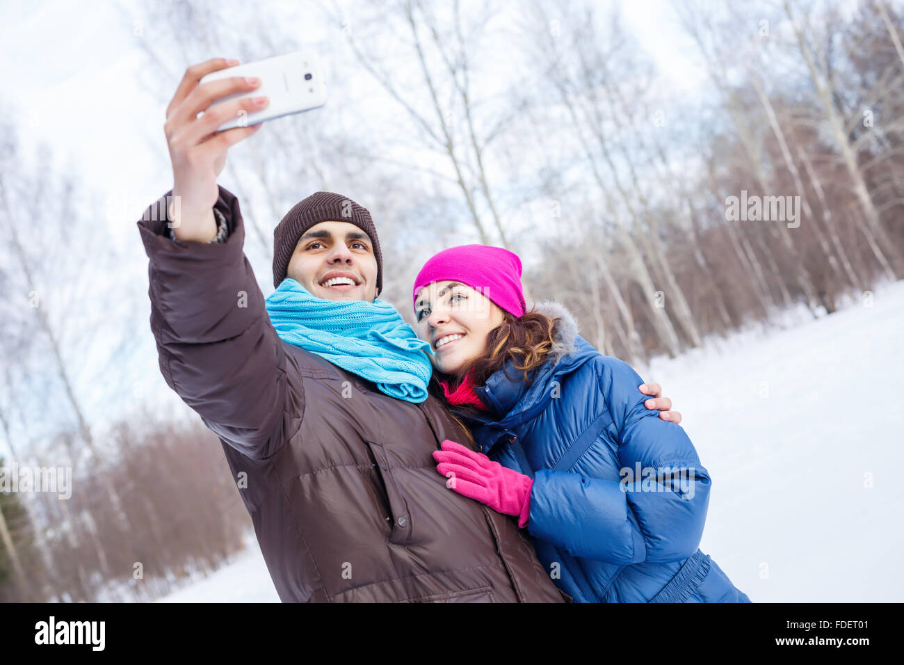 Happy young couple in winter park having fun Stock Photo - Alamy
