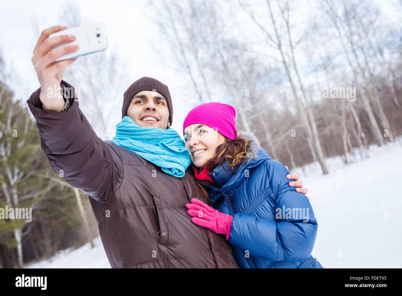 Happy young couple in winter park having fun Stock Photo - Alamy