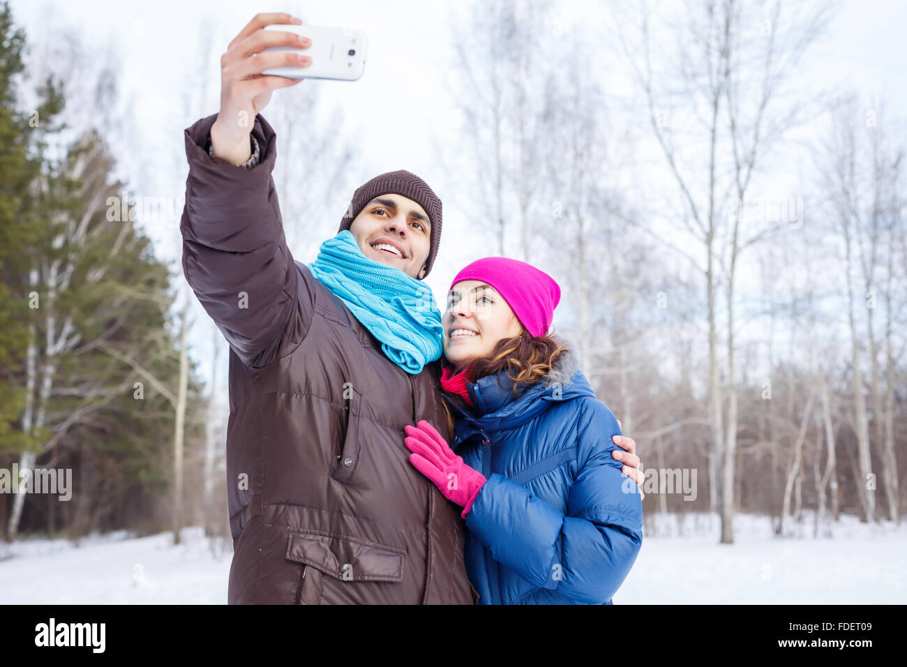 Happy young couple in winter park having fun Stock Photo - Alamy