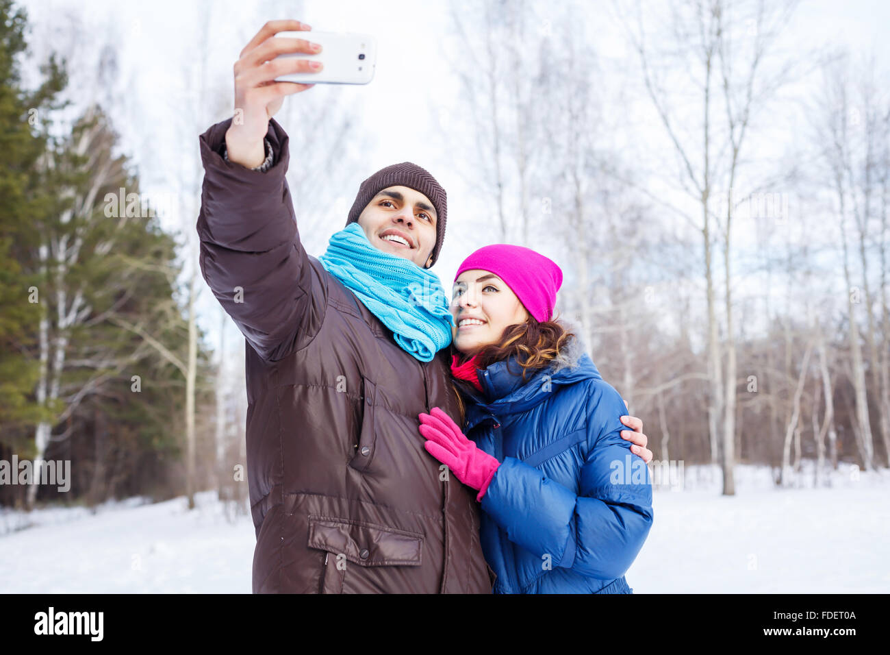 Happy young couple in winter park having fun Stock Photo - Alamy