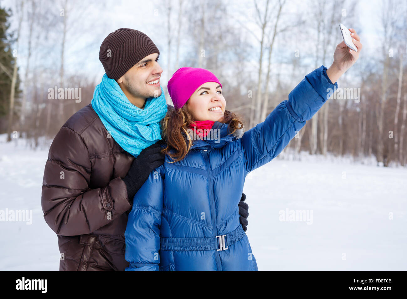 Happy young couple in winter park having fun Stock Photo - Alamy
