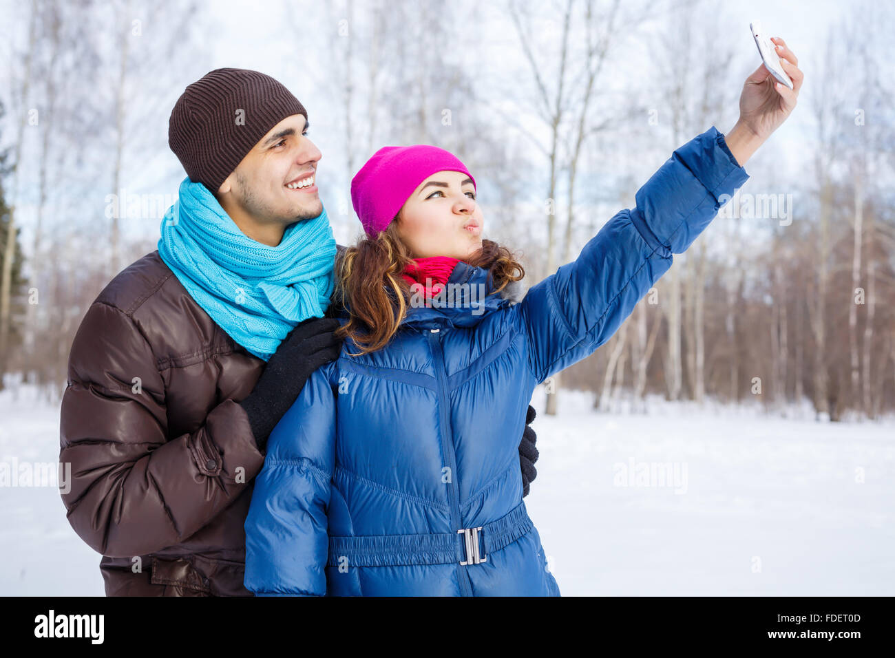 Happy young couple in winter park having fun Stock Photo - Alamy