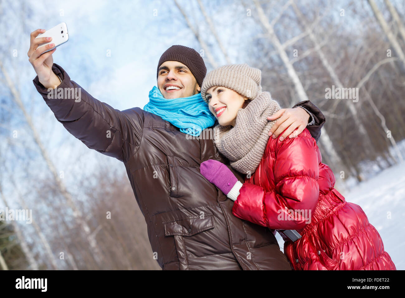 Happy young couple in winter park having fun Stock Photo - Alamy