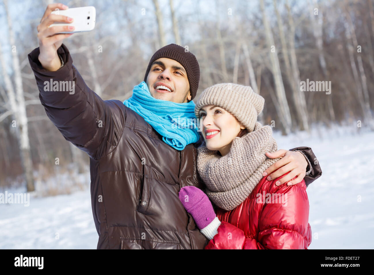 Happy young couple in winter park having fun Stock Photo - Alamy