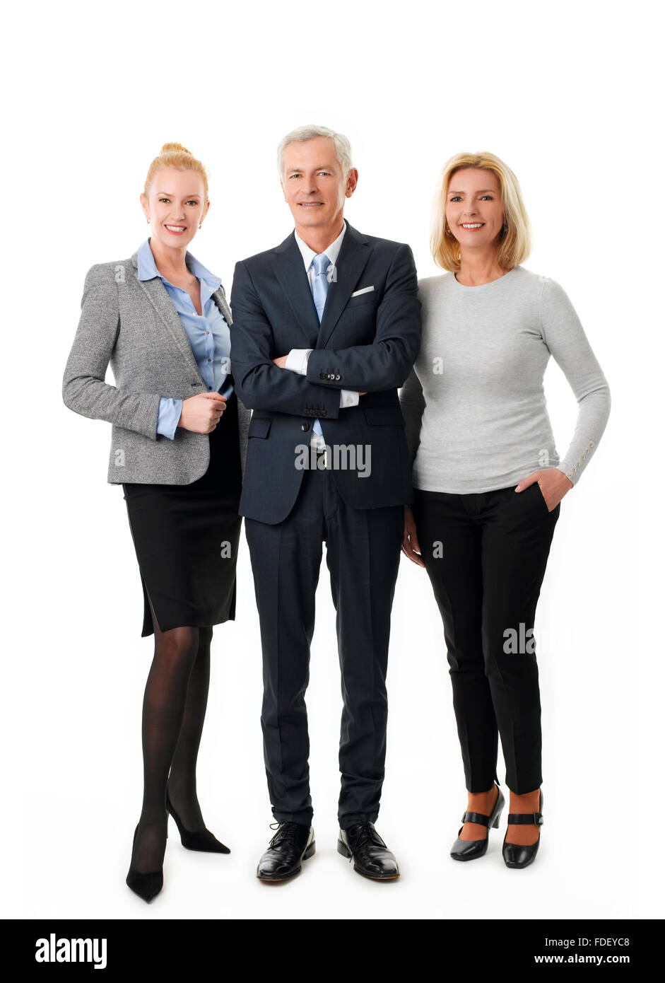 Full length portrait of successful business team standing against white background. Stock Photo