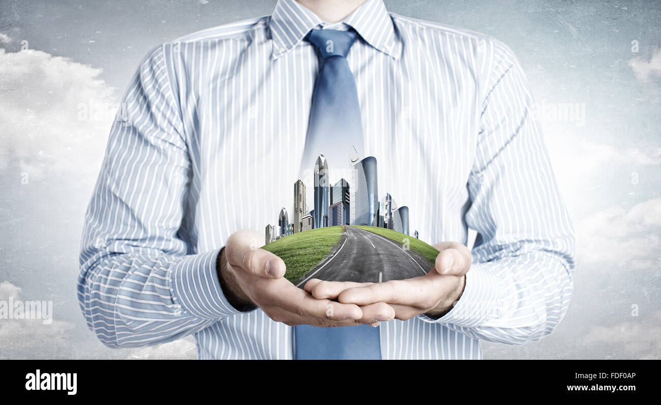 Close up of businessman hand holding modern city model Stock Photo - Alamy