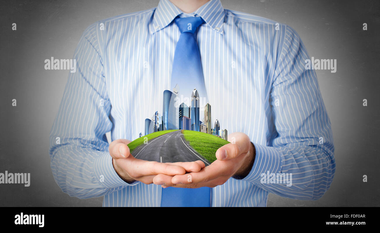 Close up of businessman hand holding modern city model Stock Photo - Alamy