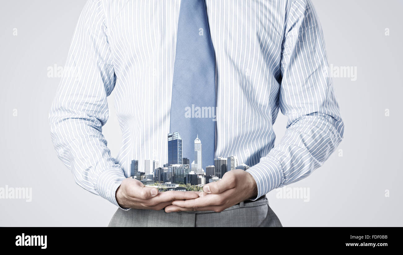 Close up of businessman holding in hands construction model Stock Photo ...