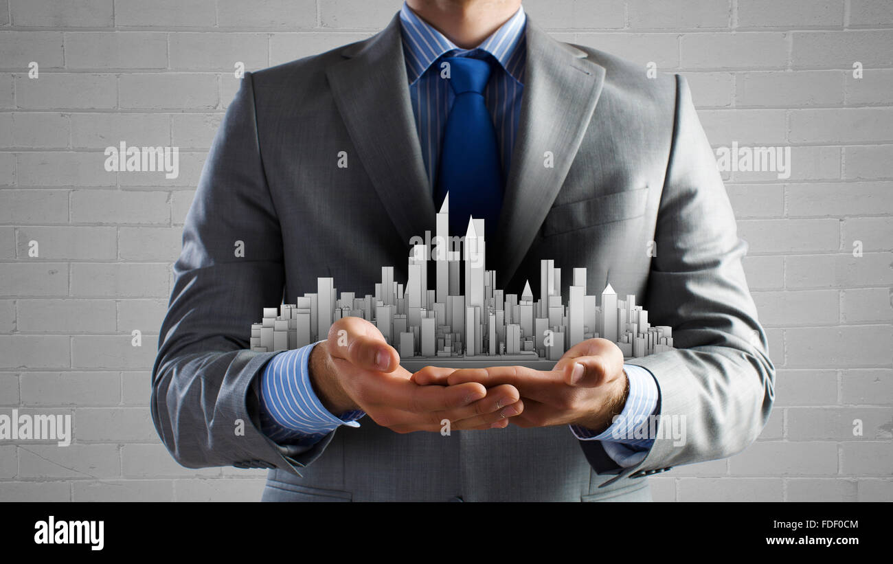 Close up of businessman hand holding construction model Stock Photo - Alamy