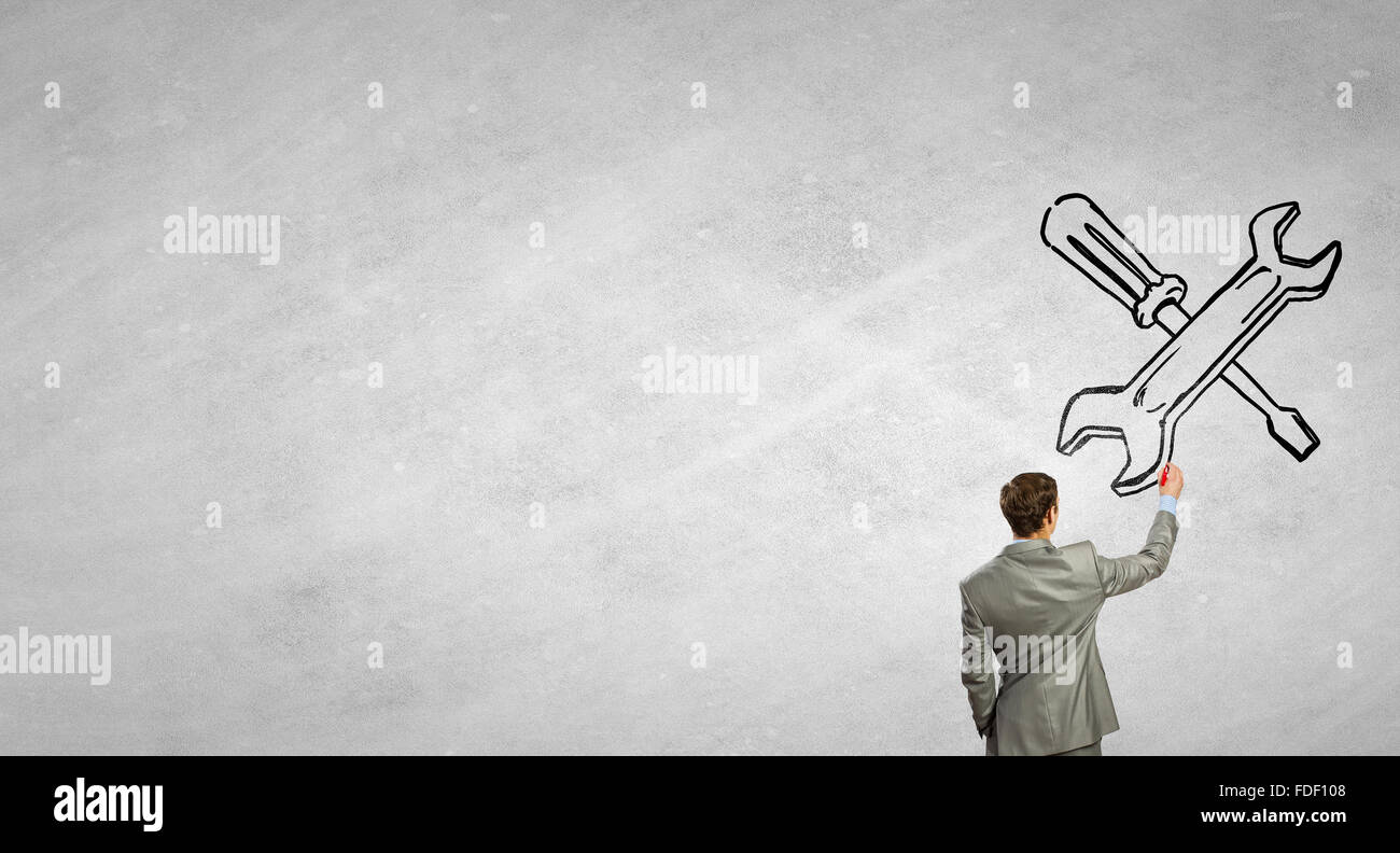 Rear View Of Businessman Drawing Tools On Wall Stock Photo Alamy