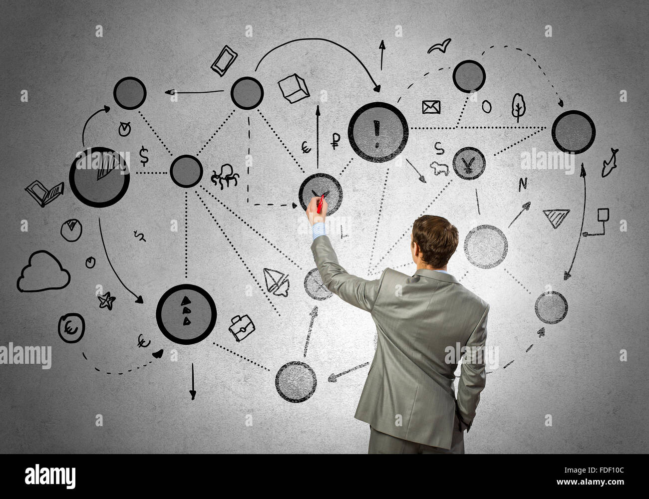 Back view of businessman drawing connection lines on wall Stock Photo