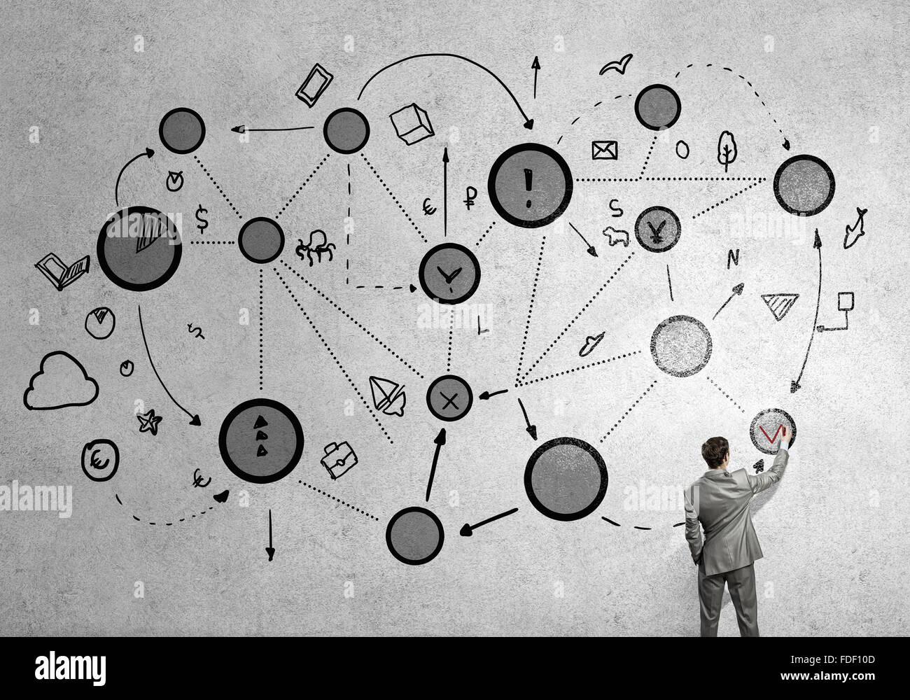 Back view of businessman drawing connection lines on wall Stock Photo