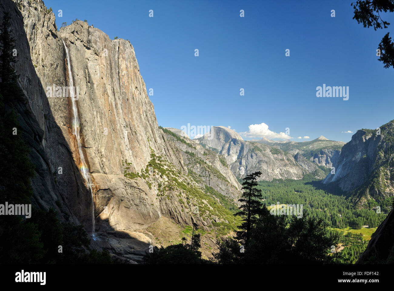 A waterfall Yosemite Falls and the Half Dome Stock Photo