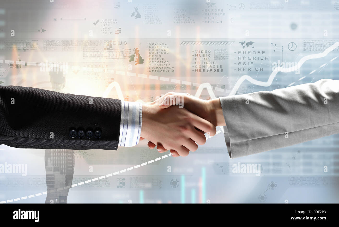 Close up of business handshake on digital background Stock Photo - Alamy