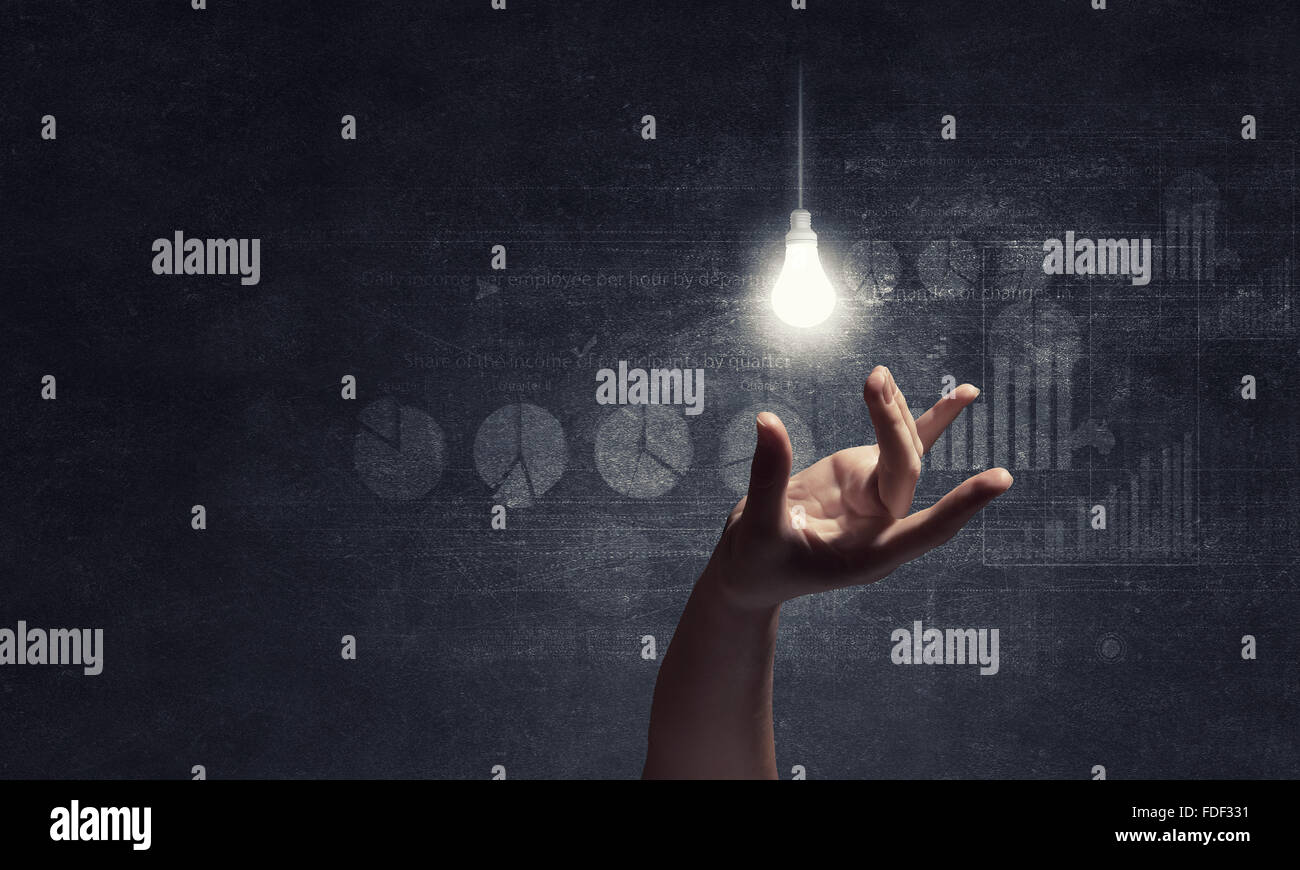 Hand catching glass light bulb with fingers Stock Photo Alamy