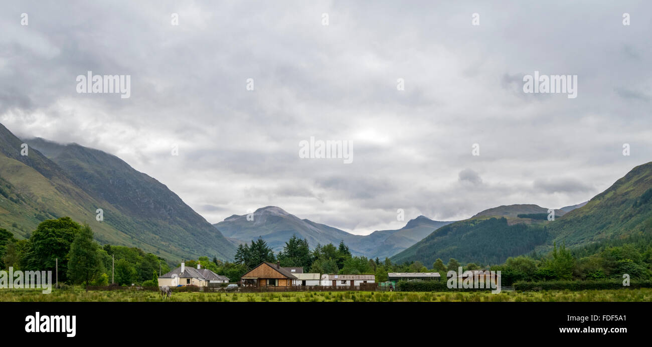 View of log cabins with the valley of Glen Nevis, Scotland, UK. Stock Photo