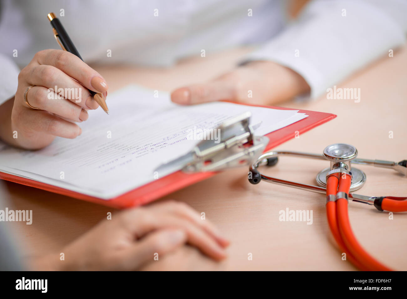 Doctor or physician making notes Stock Photo