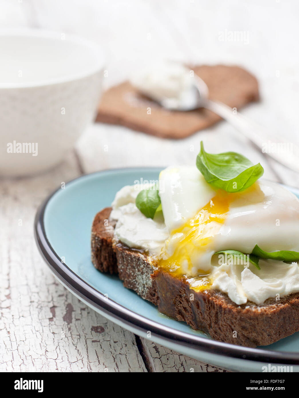 Toast With Poached Egg Cottage Cheese And Basil Leaves On A