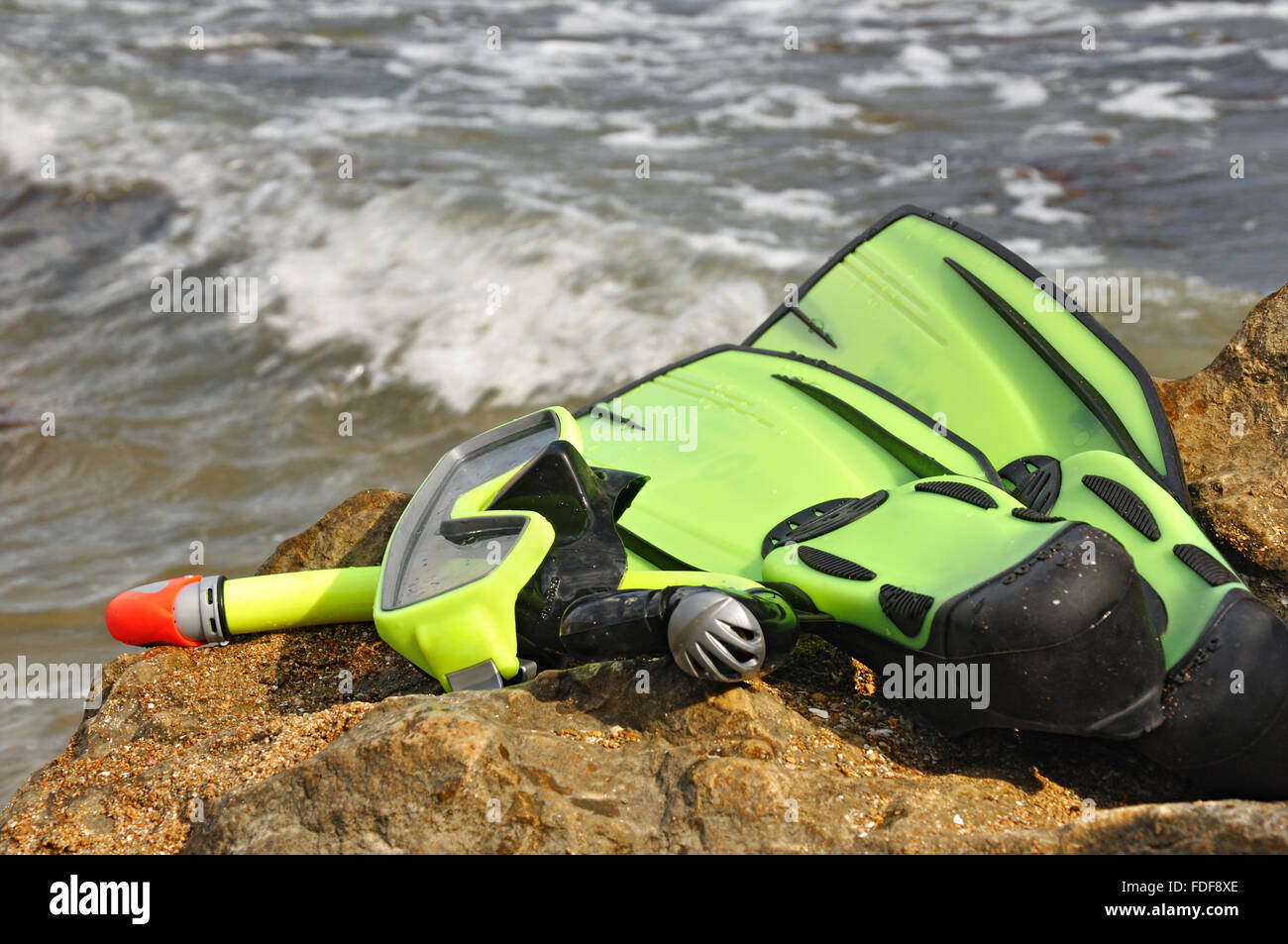 Diving mask, snorkel and flippers on seacoast. Equipment for diving Stock Photo