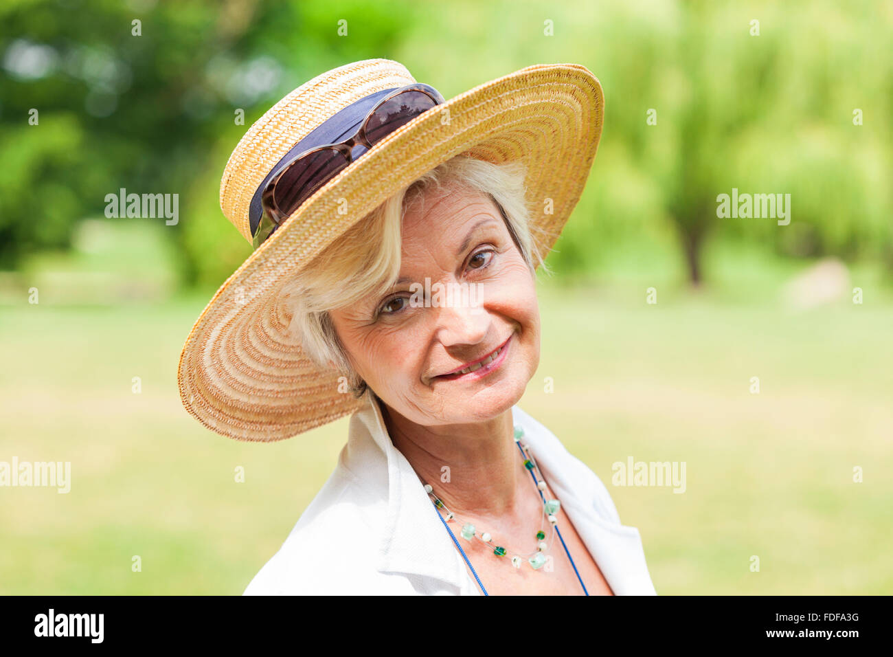senior old woman outdoor with hat smiling Stock Photo