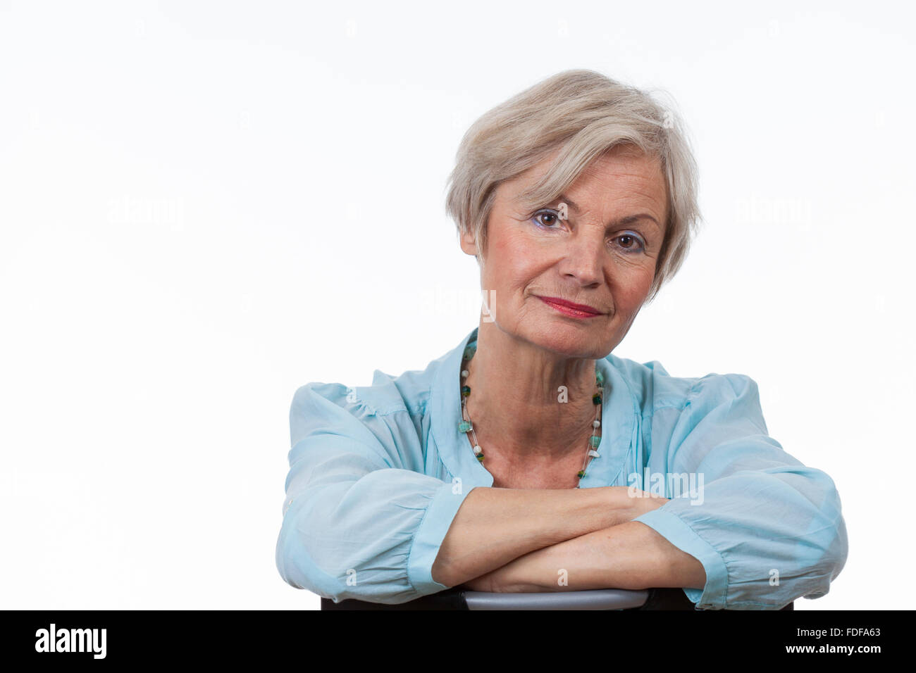 attractive beautiful senior old woman smiling thoughtful on isolated white background Stock Photo