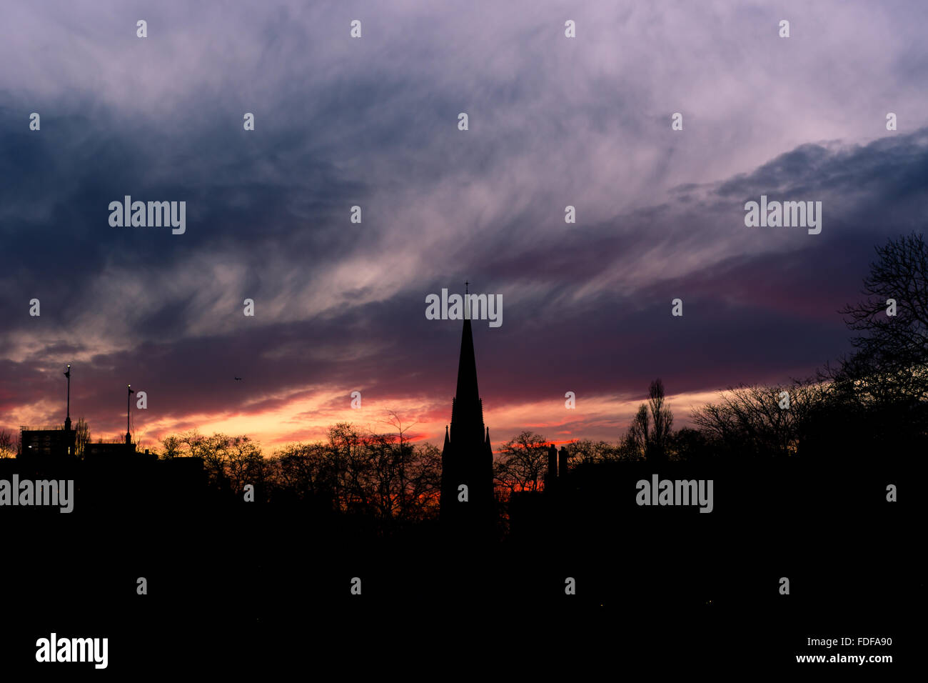 St. Mary Abbot's Church, Kensington. A silhouette of a church spire in central London, against an impressive sunset Stock Photo