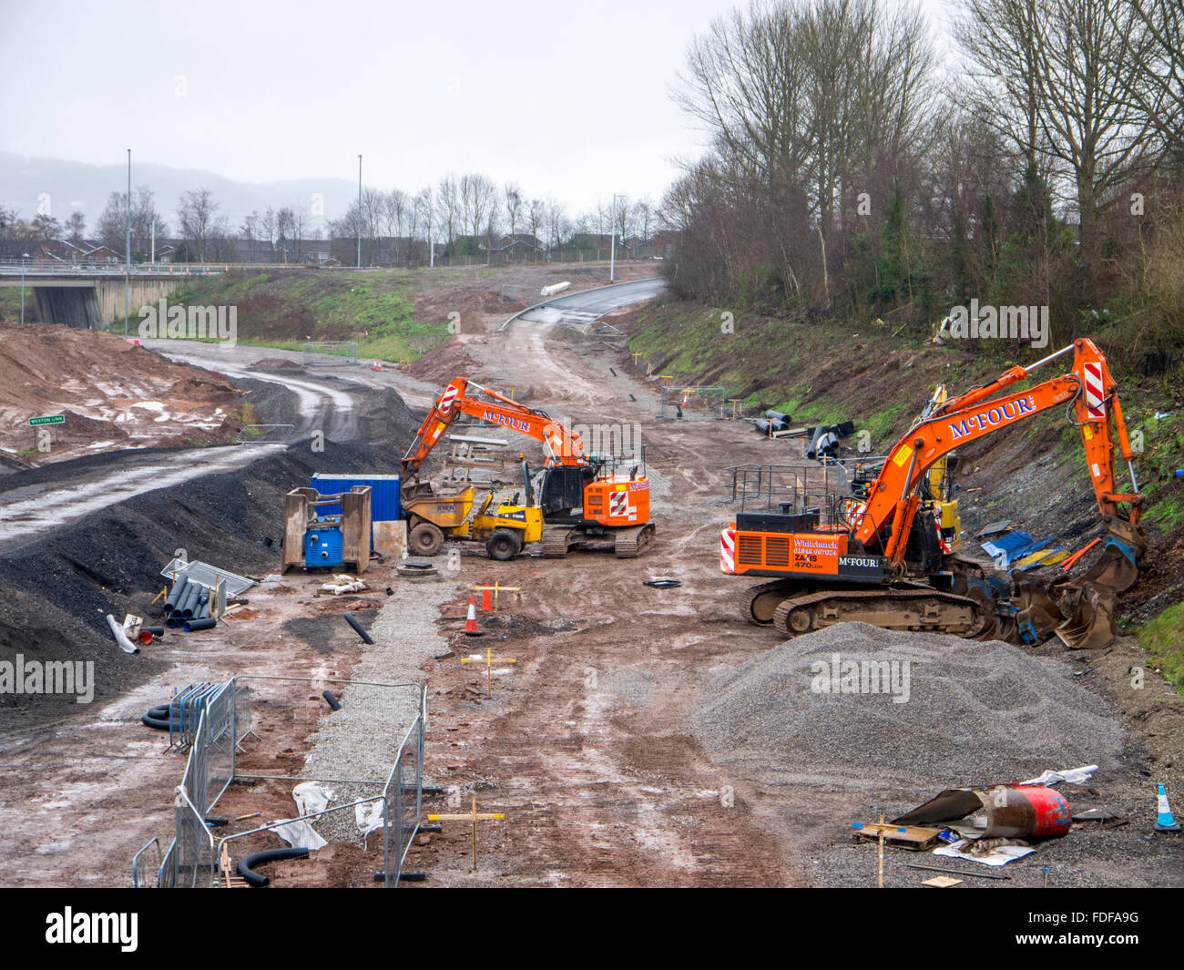 Diggers working on a road construction site Stock Photo