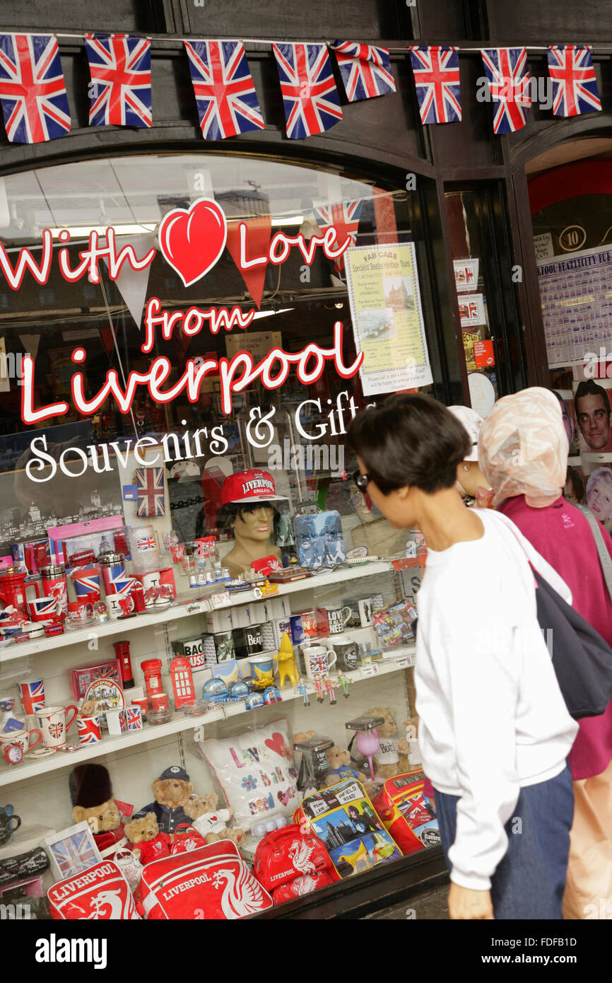 Tourists looking at gift shop window display, Albert Dock, Liverpool
