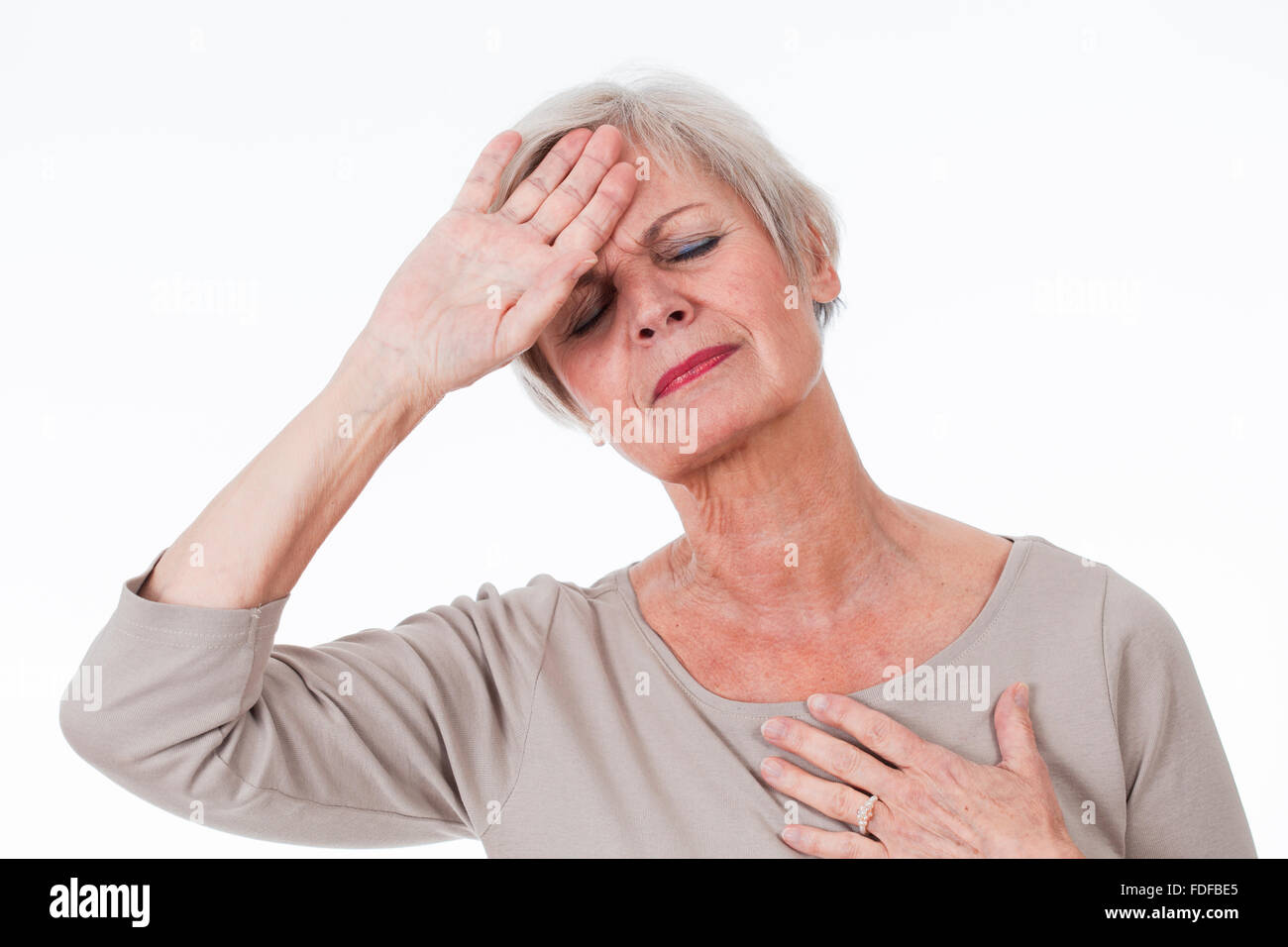 senior older woman with migraine and tooth pain Stock Photo