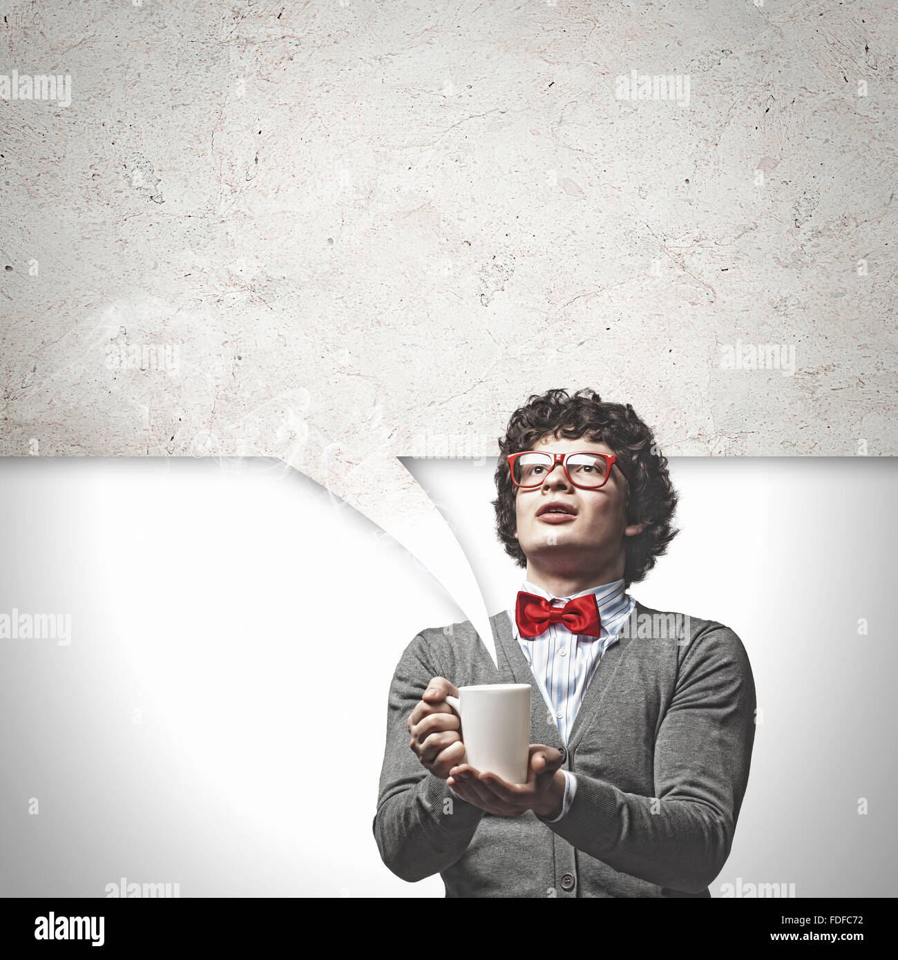 Young man with blank frames against a grey wall Stock Photo - Alamy