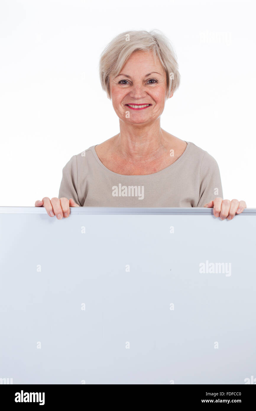 beautiful happy smiling older senior women holding sign with text space for advertising Stock Photo