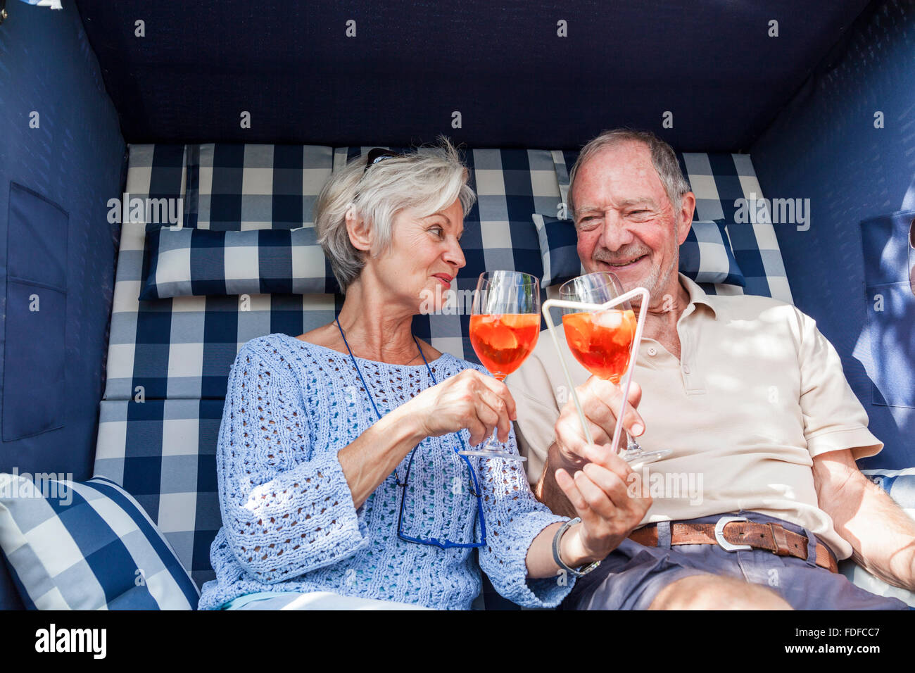 happy senior couple in garden smiling and laughing in sunshine enjoying retirement Stock Photo