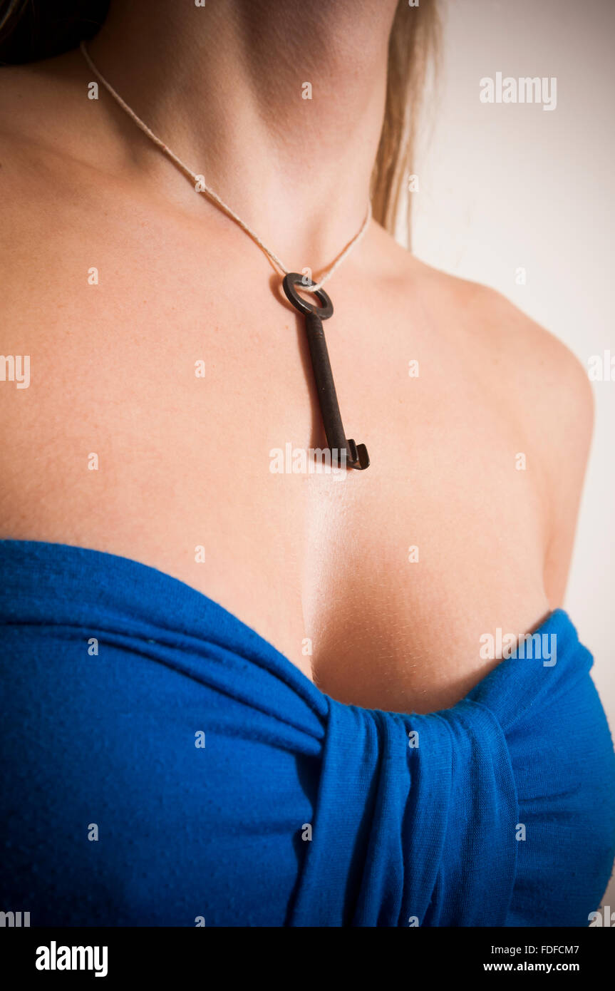 Close up of a woman wearing an old skeleton key around her neck Stock