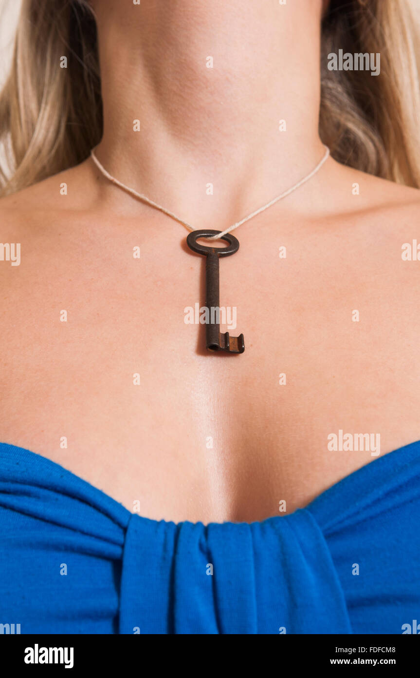 Close up of a woman wearing an old skeleton key around her neck Stock