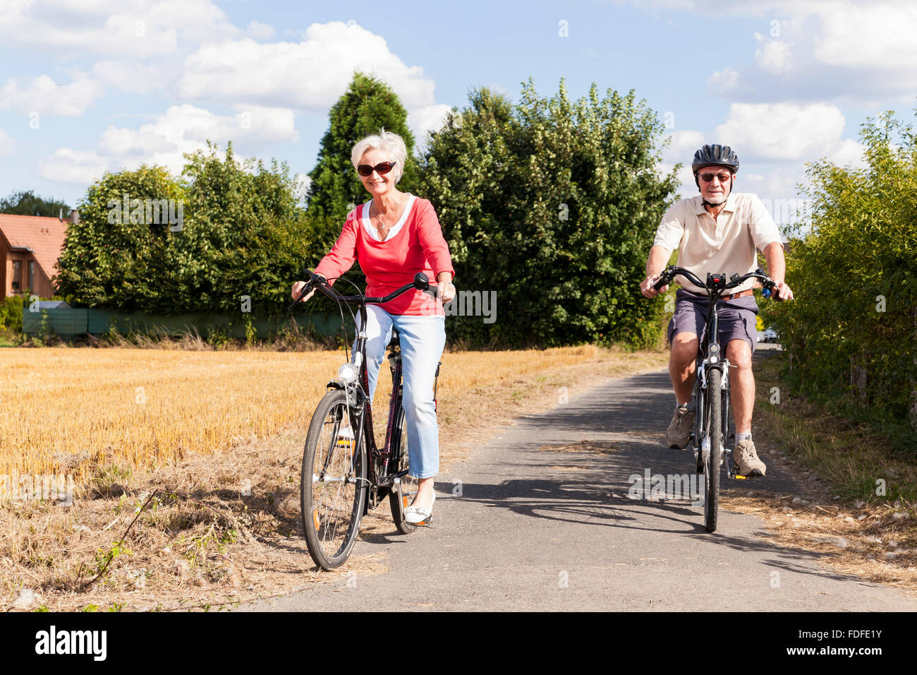 attractive active senior people on bike trip in spring summer fall autumn Stock Photo